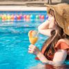 プールで飲み物を飲む女性